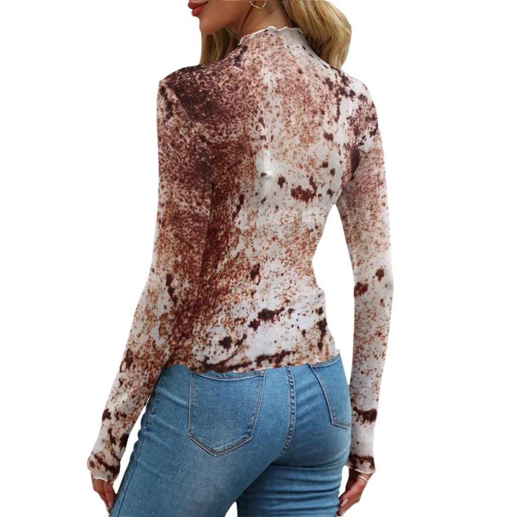 A woman shown from the back wearing a long-sleeve mock-neck top with a brown and white mottled splatter pattern, paired with blue jeans, against a plain white background.