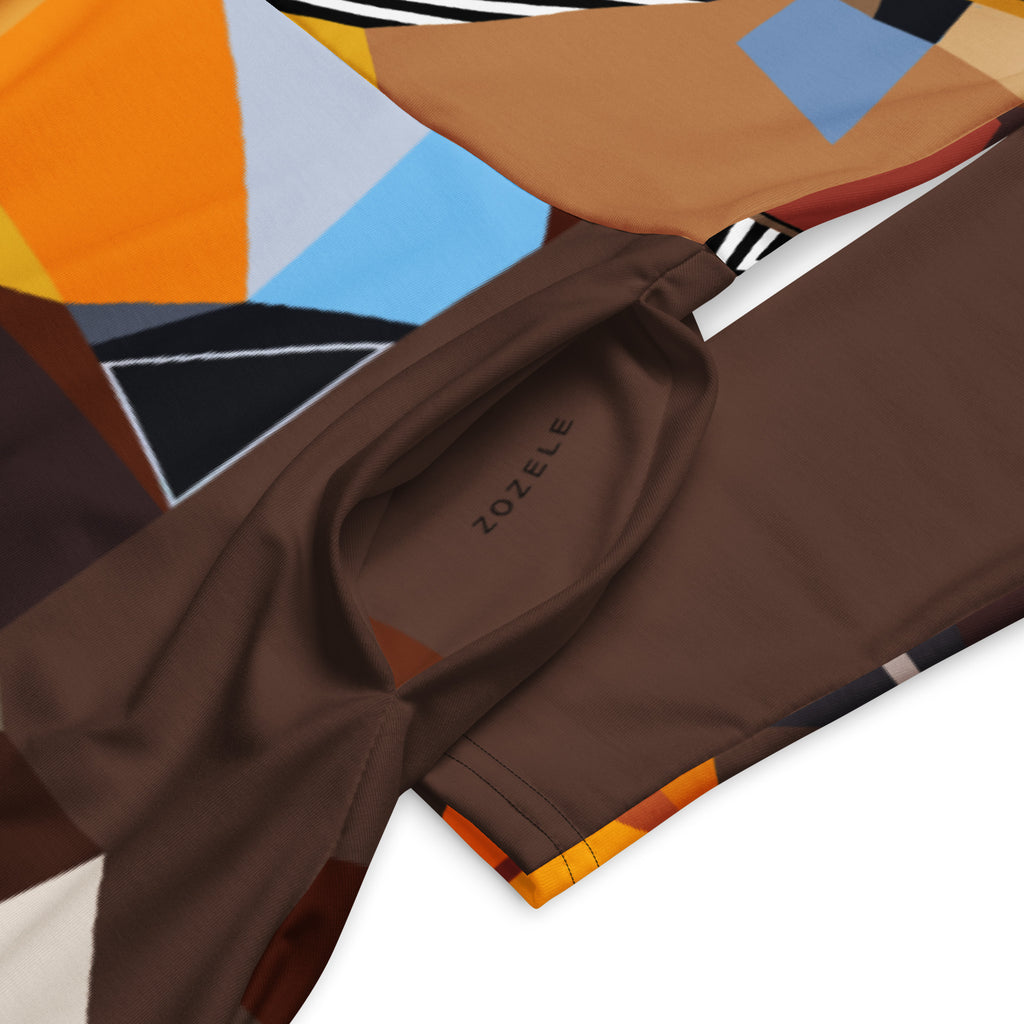 Close-up detail of geometric pattern and fabric on a brown artistic midi dress with long sleeves and pockets