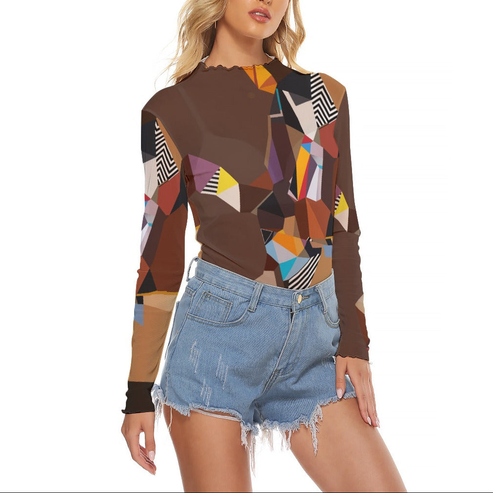 Woman wearing a colorful geometric-patterned top and denim shorts on a white background