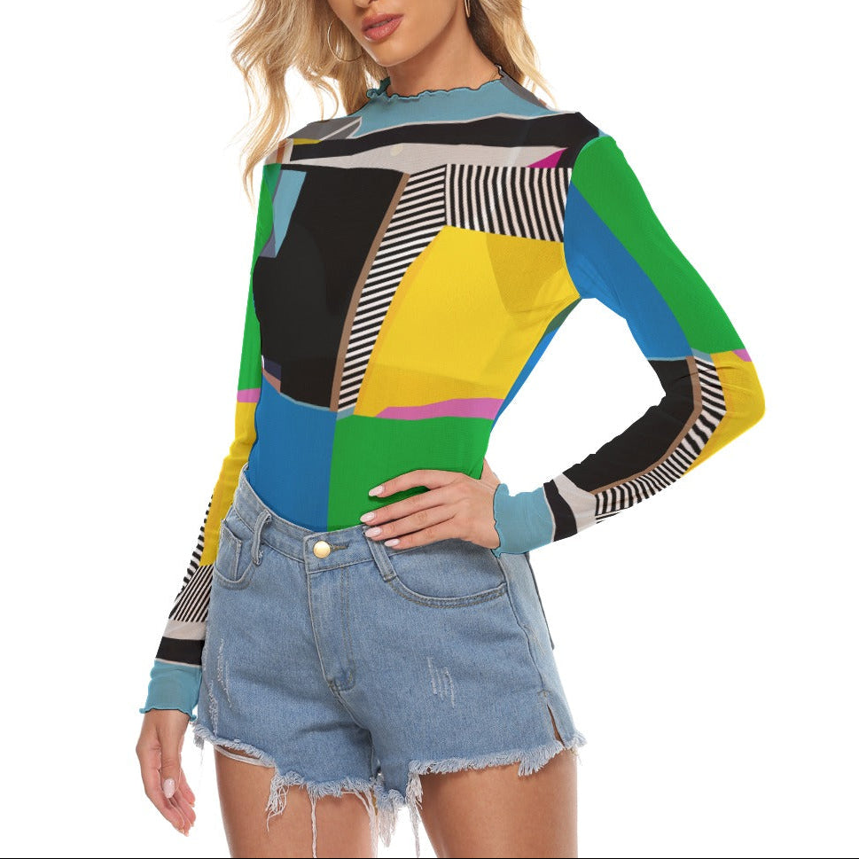 Woman wearing a colorful colorblock geometric-patterned sweater and denim shorts on a white background