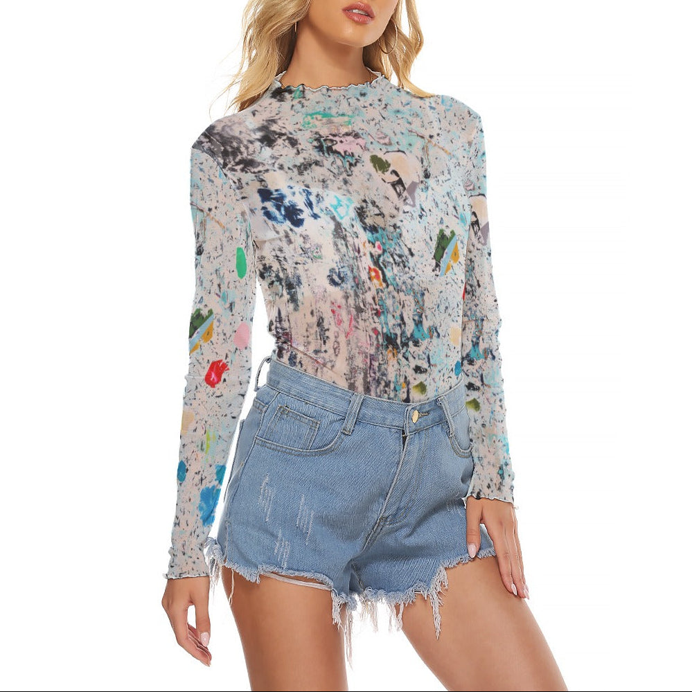 Woman wearing a floral long-sleeve top and denim shorts on a white background
