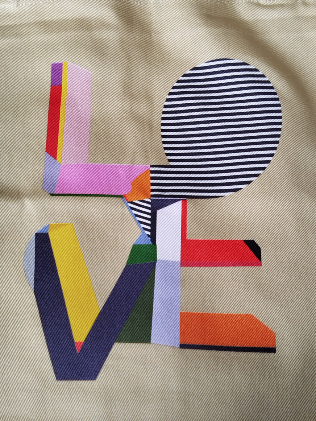 Close up of unique original LOVE print on natural organic cotton fabric