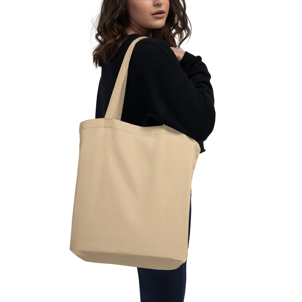 Woman wearing eco friendly organic cotton LOVE tote bag over the shoulder